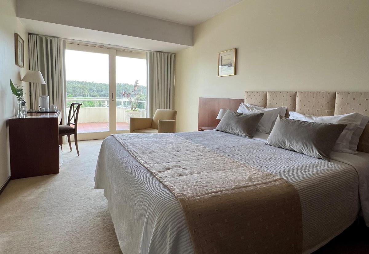 Uma cama ou camas num quarto em Santana Hotel & SPA