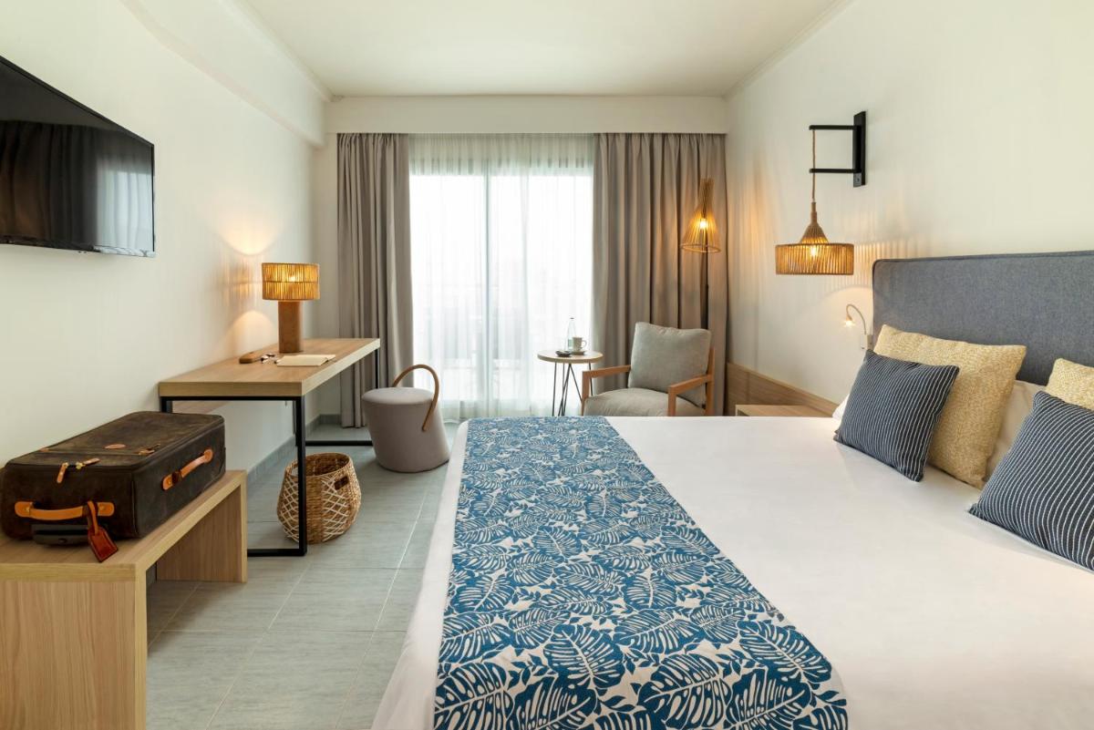 Cama o camas de una habitación en Hotel Cabogata Jardín