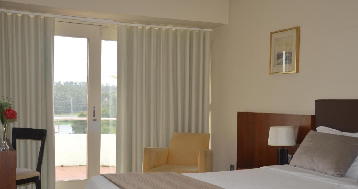 Uma cama ou camas num quarto em Santana Hotel & SPA