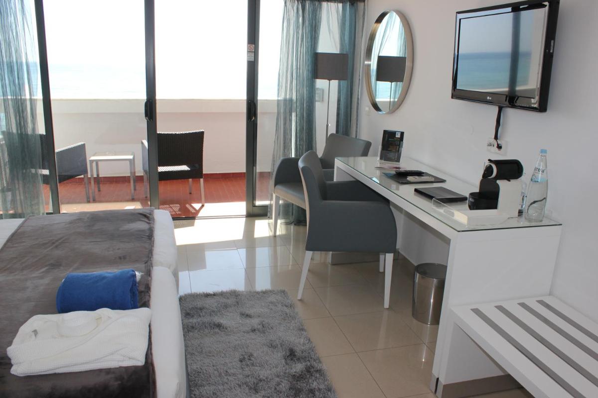 Uma televisão e/ou sistema de entretenimento em Rocamar Exclusive Hotel & Spa - Adults Only