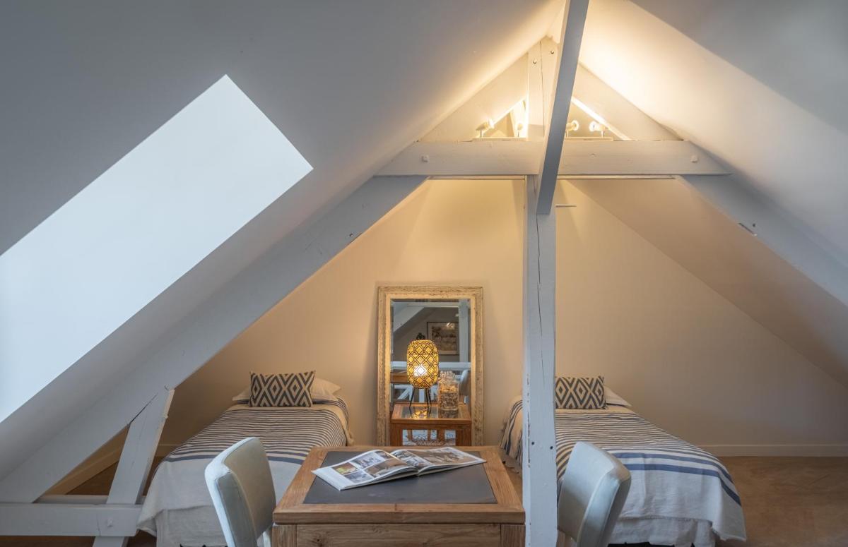 Un ou plusieurs lits dans un hébergement de l'établissement La Marine de Loire Hôtel & Spa