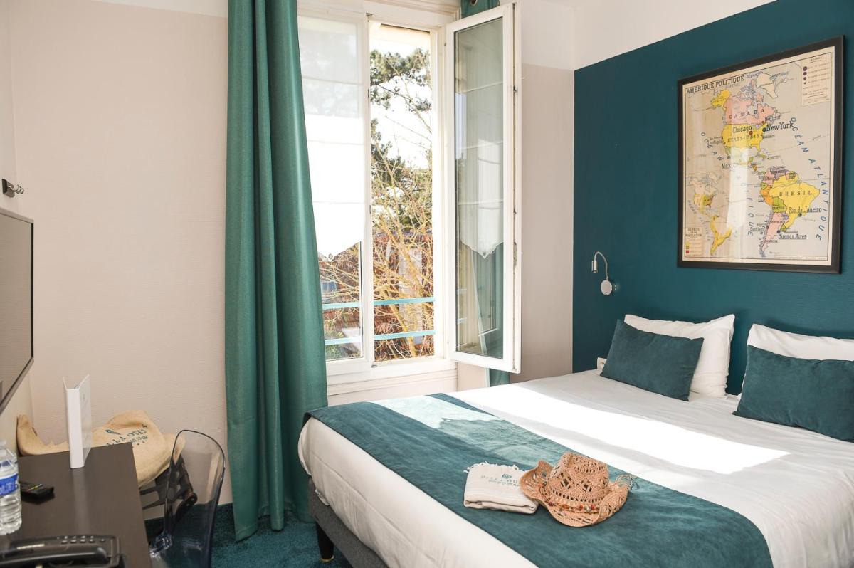 Un ou plusieurs lits dans un hébergement de l'établissement The Originals Boutique Hôtel La Villa Ouest & Spa