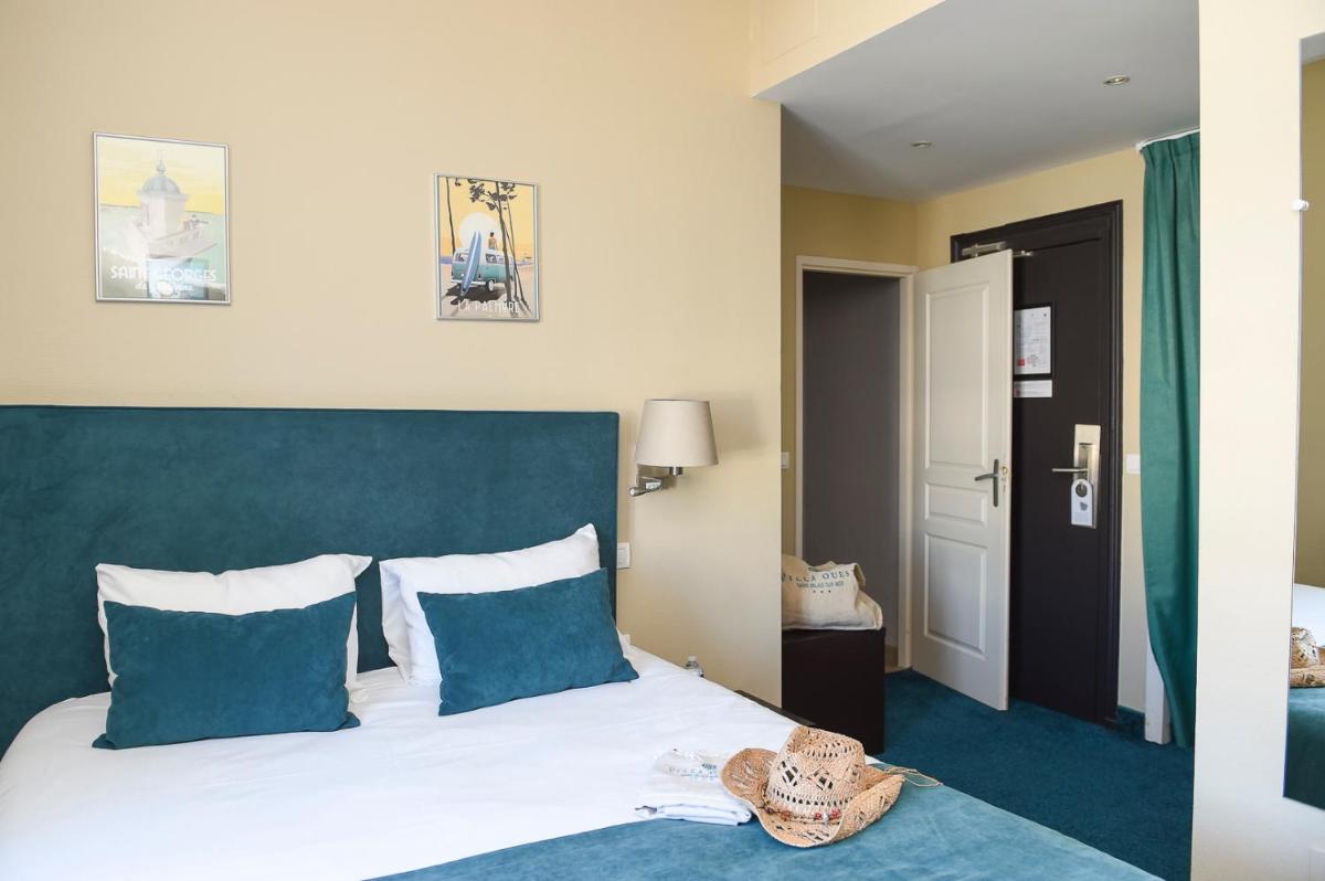 Un ou plusieurs lits dans un hébergement de l'établissement The Originals Boutique Hôtel La Villa Ouest & Spa