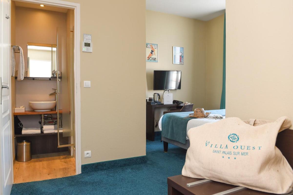 Un ou plusieurs lits dans un hébergement de l'établissement The Originals Boutique Hôtel La Villa Ouest & Spa