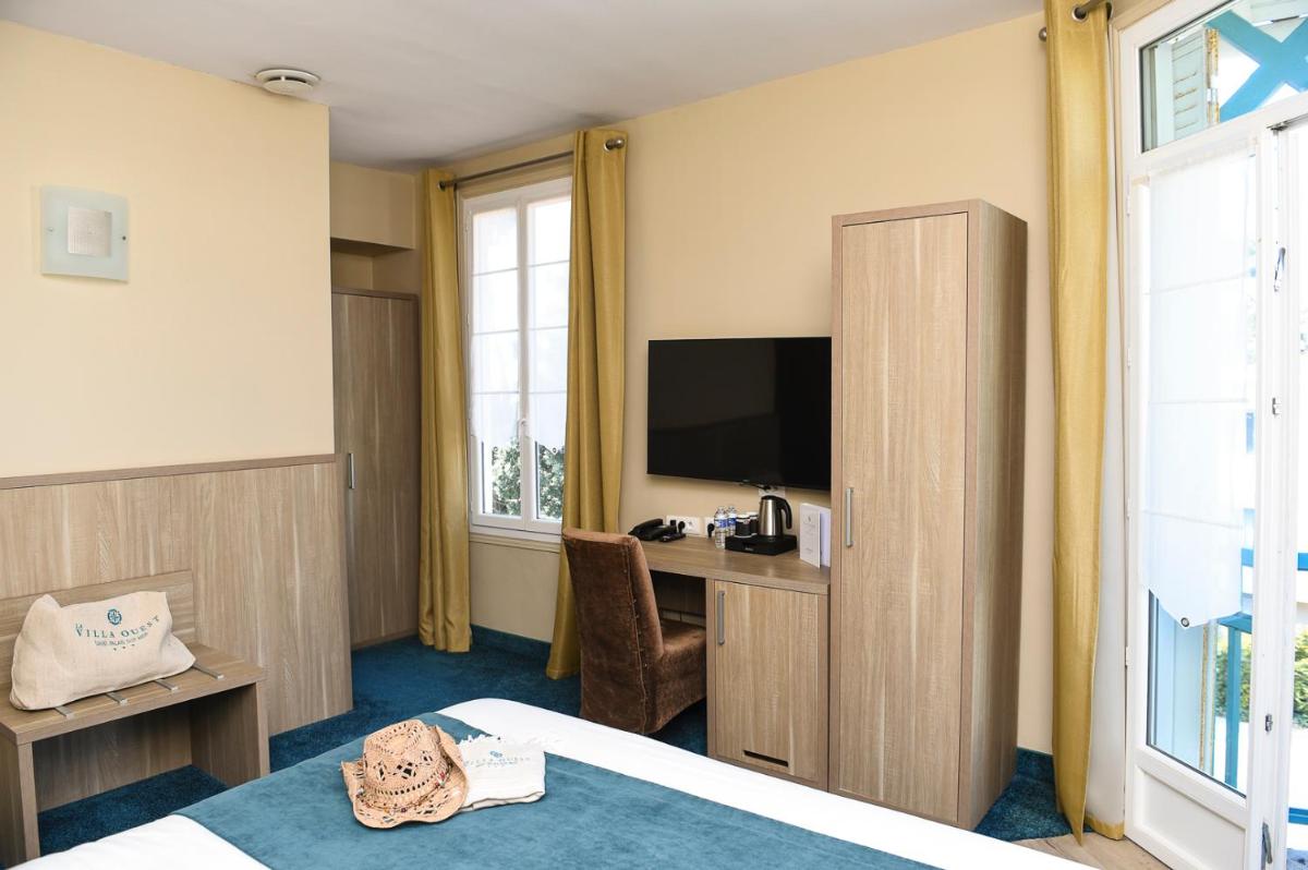 Télévision ou salle de divertissement dans l'établissement The Originals Boutique Hôtel La Villa Ouest & Spa
