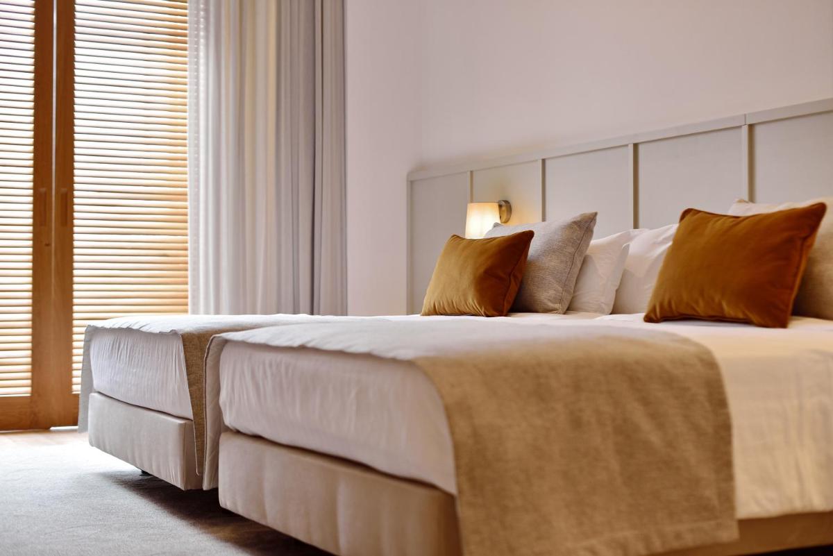 Uma cama ou camas num quarto em Dolce CampoReal Lisboa