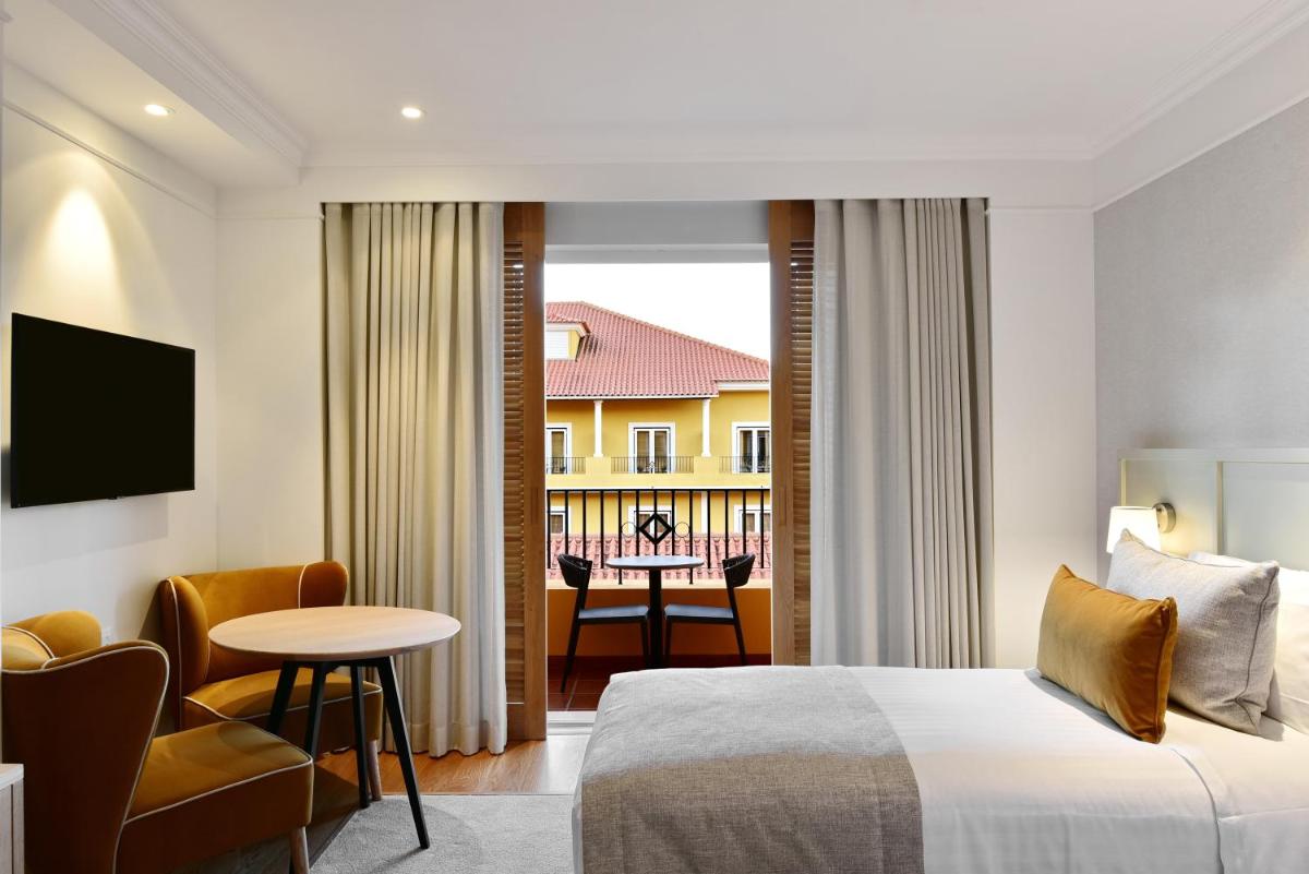 Uma cama ou camas num quarto em Dolce CampoReal Lisboa