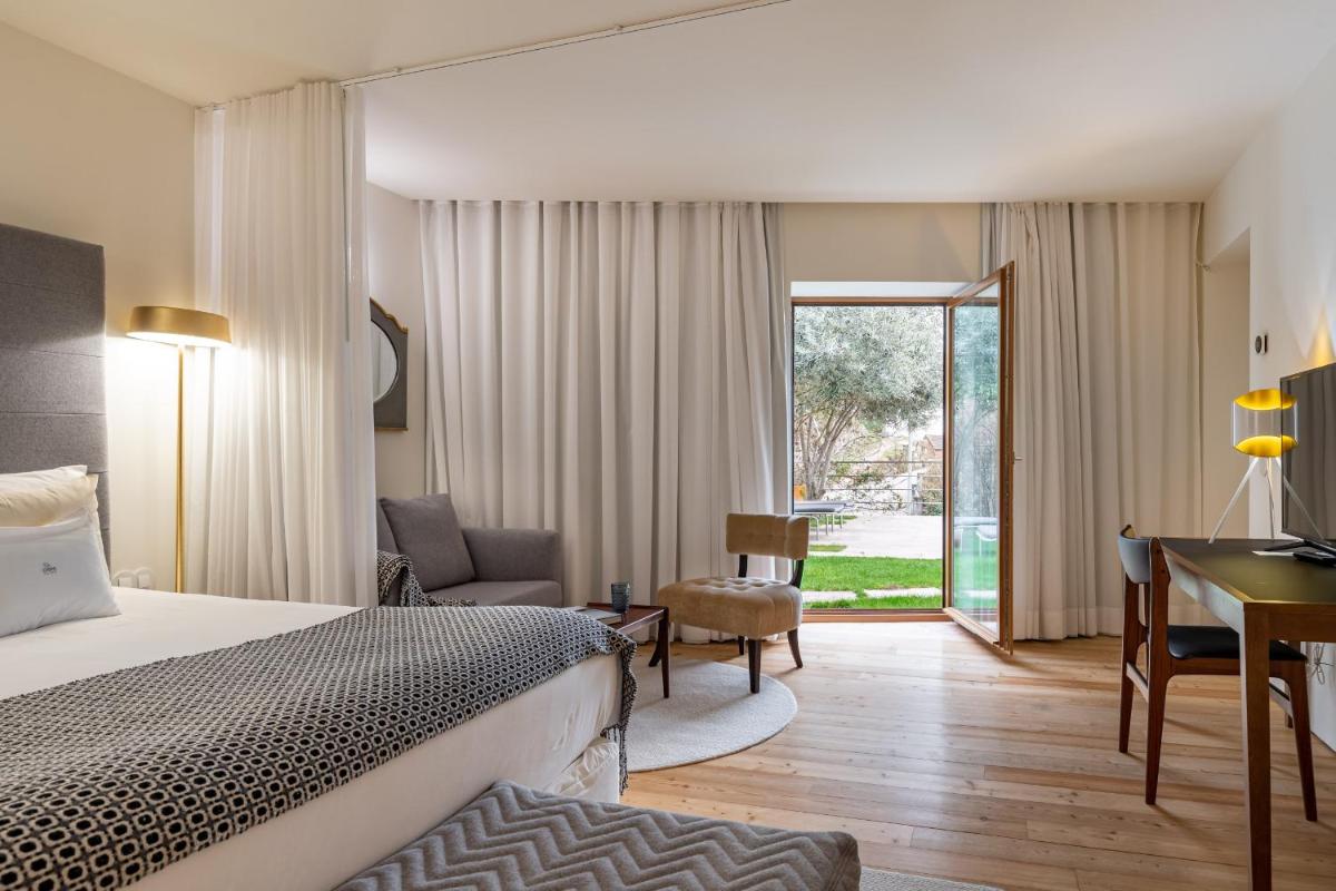 Uma cama ou camas num quarto em Casas Da Lapa, Nature & Spa Hotel