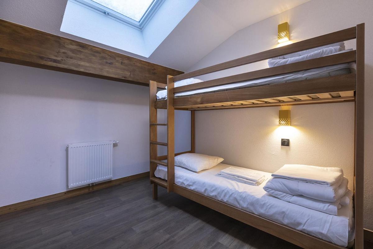 Un ou plusieurs lits dans un hébergement de l'établissement Résidence Club MMV Les Chalets des Cimes
