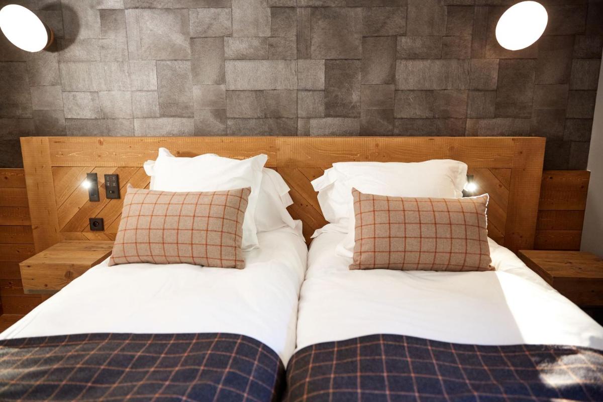 Un ou plusieurs lits dans un hébergement de l'établissement Pure Montagne Resort & Spa