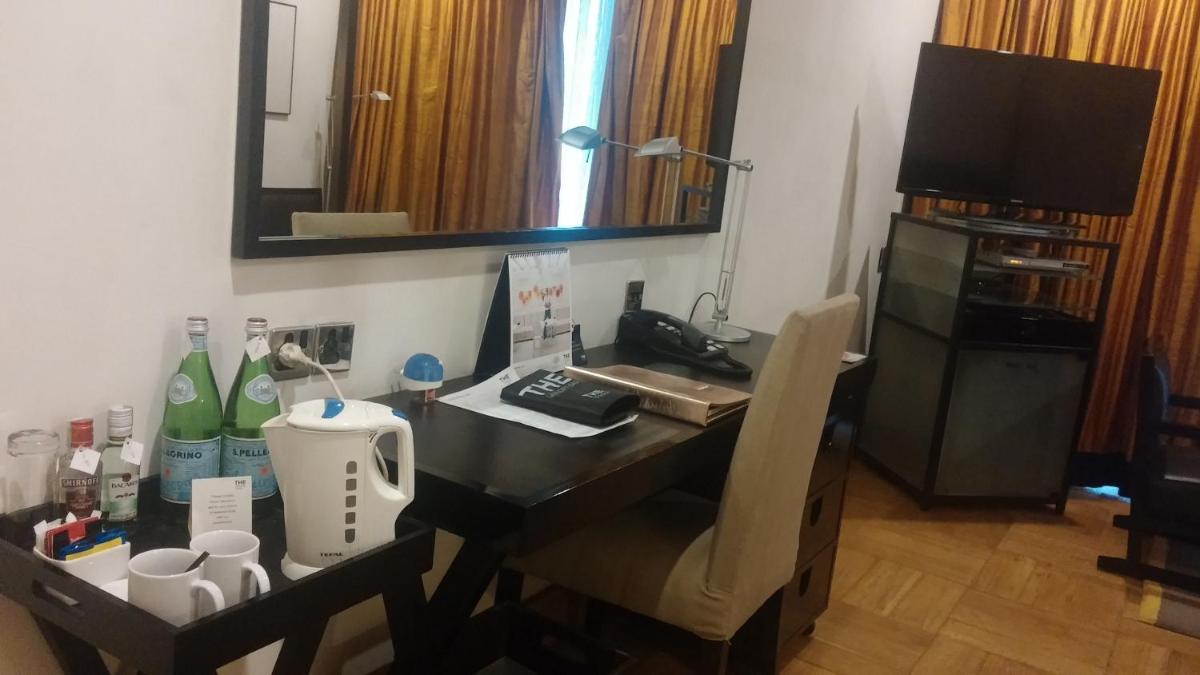 a desk with a chair and a table with a mirror at The Park Bangalore, MG Road in Bengaluru a desk with a chair and a table with a mirror at The Park Bangalore, MG Road in Bengaluru