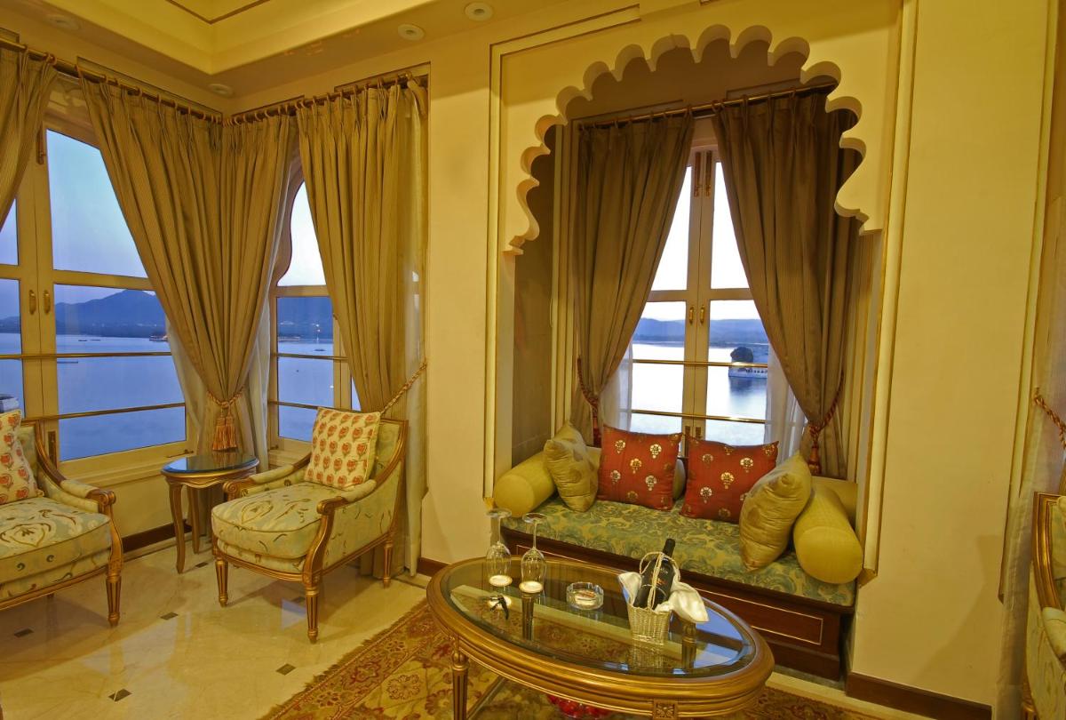 a living room with a couch and some windows at Taj Fateh Prakash Palace Udaipur in Udaipur