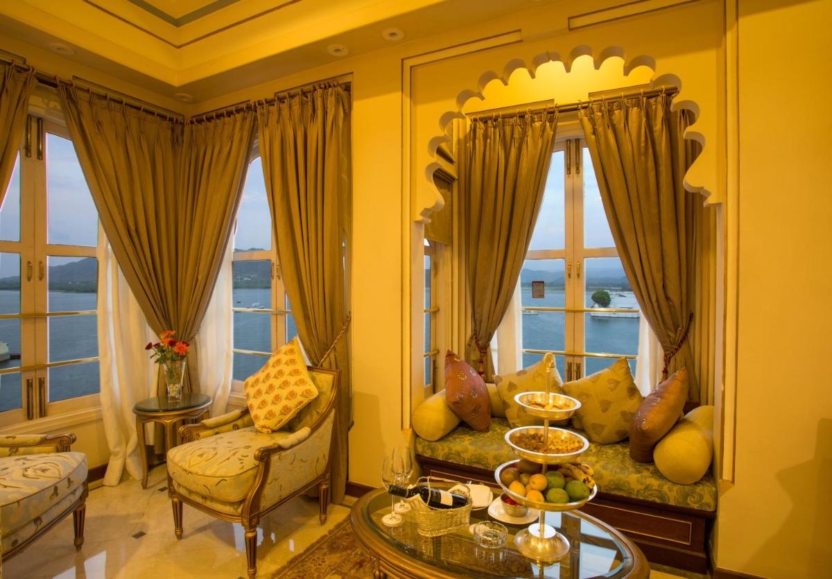 a living room with a couch and some windows at Taj Fateh Prakash Palace Udaipur in Udaipur