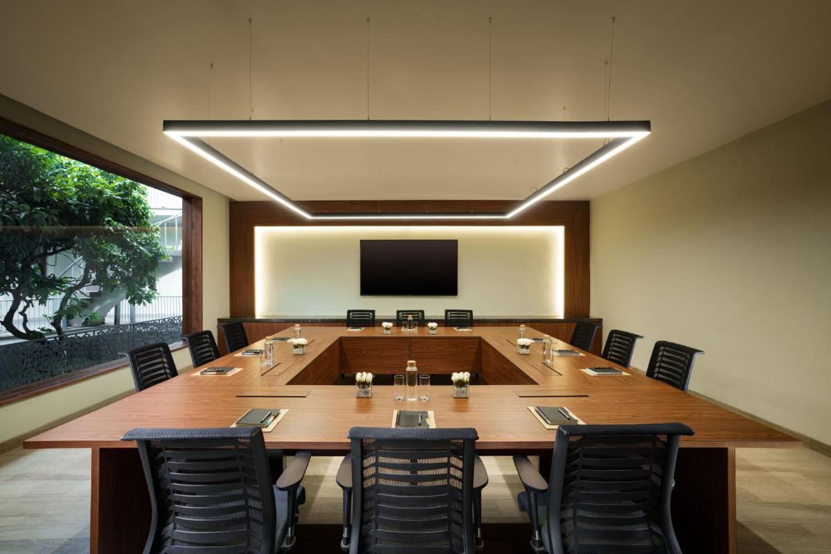a large conference room with a large wooden table and chairs at Anand Kashi by the Ganges Rishikesh - IHCL Seleqtions in Rishīkesh +107 photos