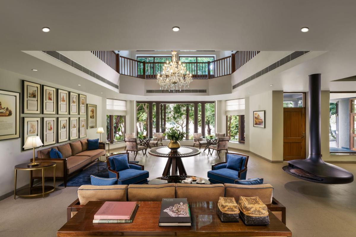 a large living room with couches and a chandelier at Anand Kashi by the Ganges Rishikesh - IHCL Seleqtions in Rishīkesh
