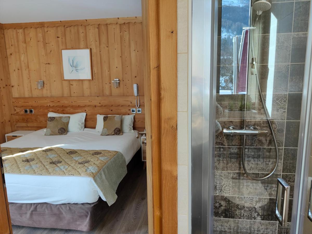 Un ou plusieurs lits dans un hébergement de l'établissement Aiguille du Midi - Hôtel & Restaurant