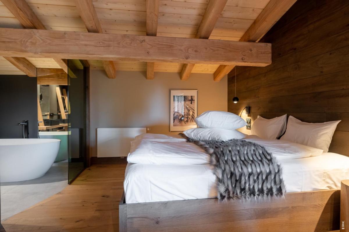 Un ou plusieurs lits dans un hébergement de l'établissement Chalet Hôtel & Spa Le Collet