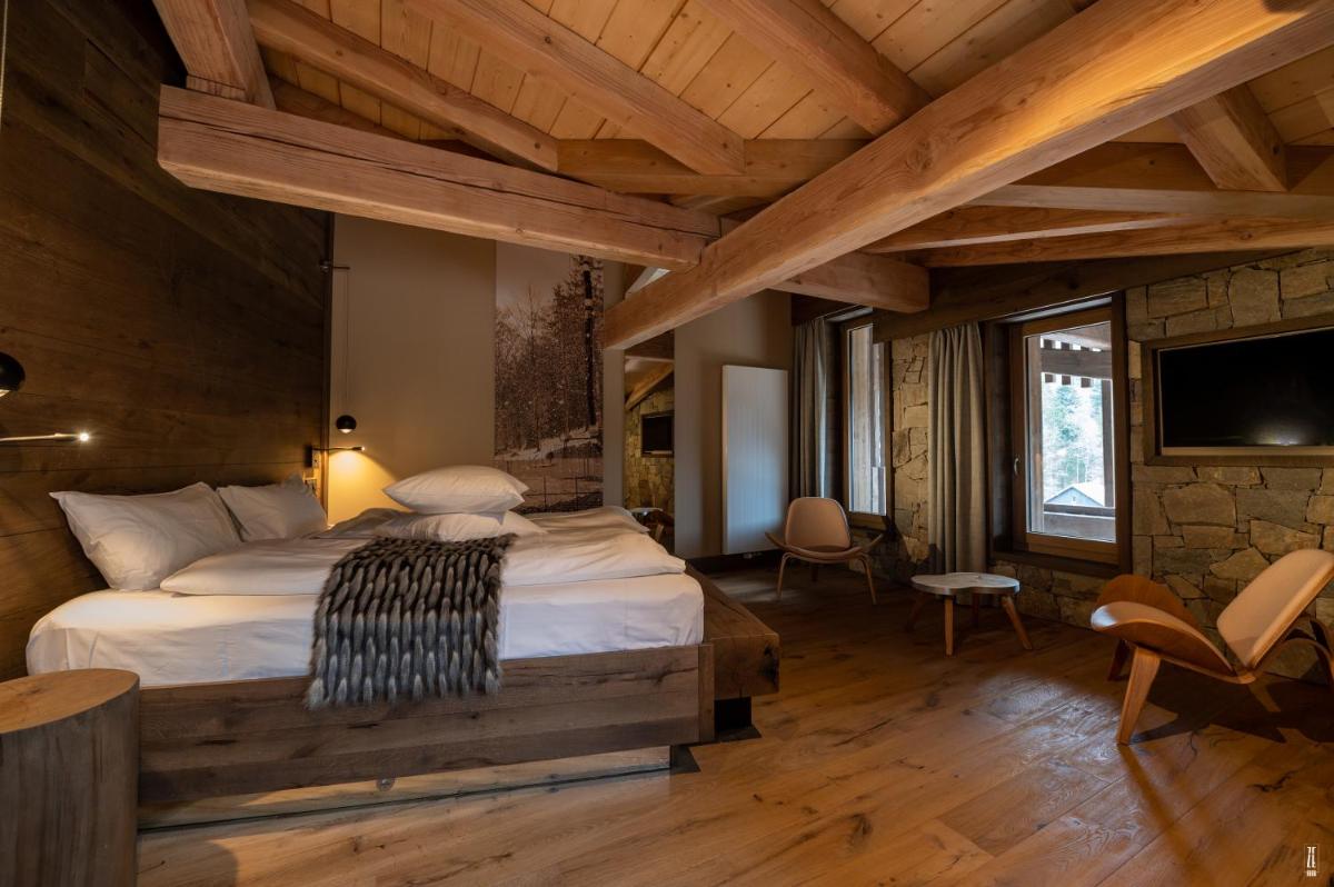 Un ou plusieurs lits dans un hébergement de l'établissement Chalet Hôtel & Spa Le Collet
