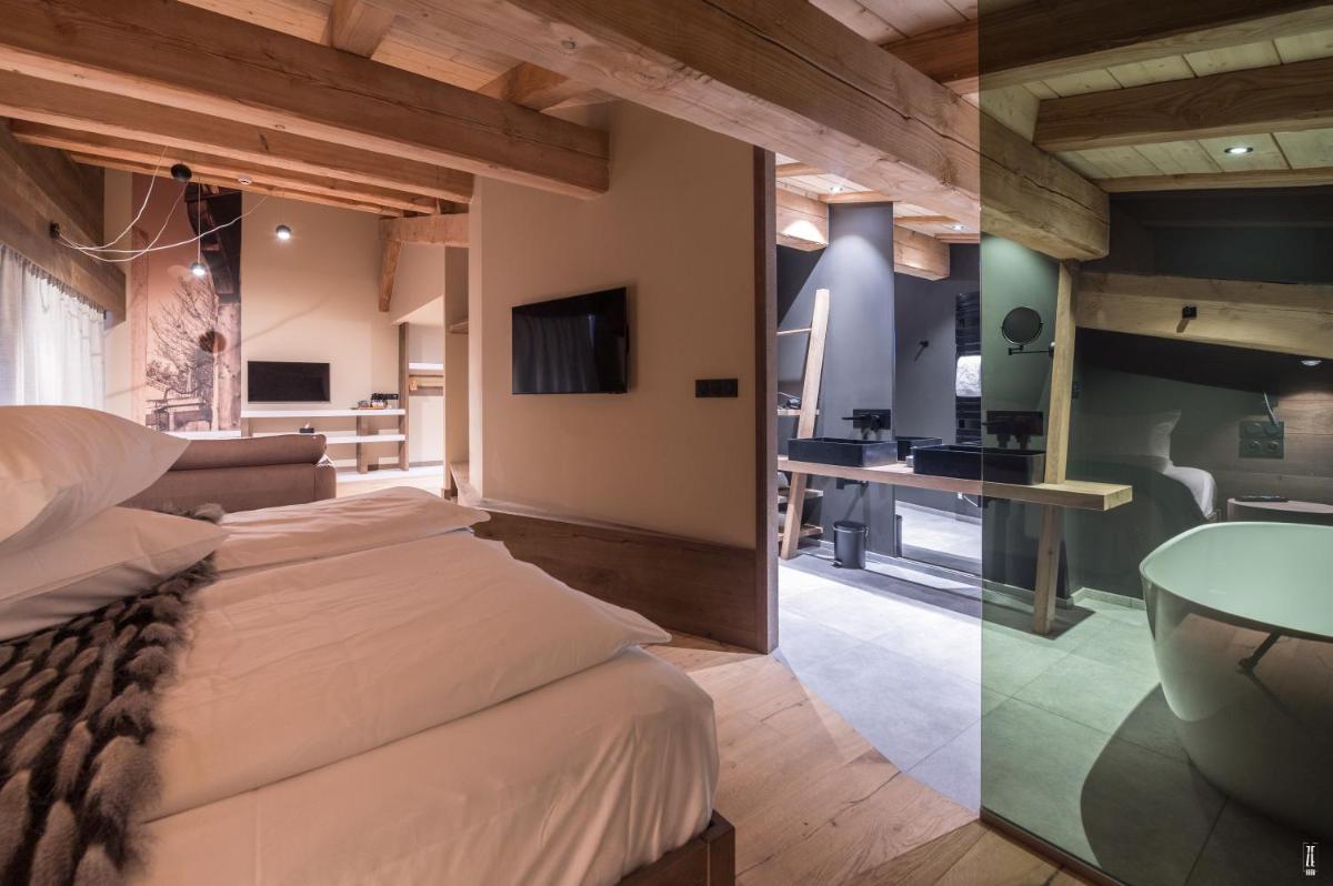 Un ou plusieurs lits dans un hébergement de l'établissement Chalet Hôtel & Spa Le Collet