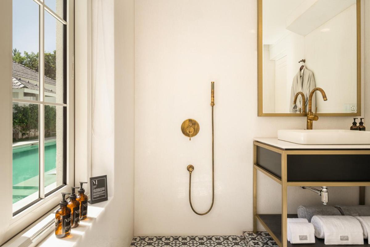 a bathroom with a sink and a shower at MansionHaus in Anjuna