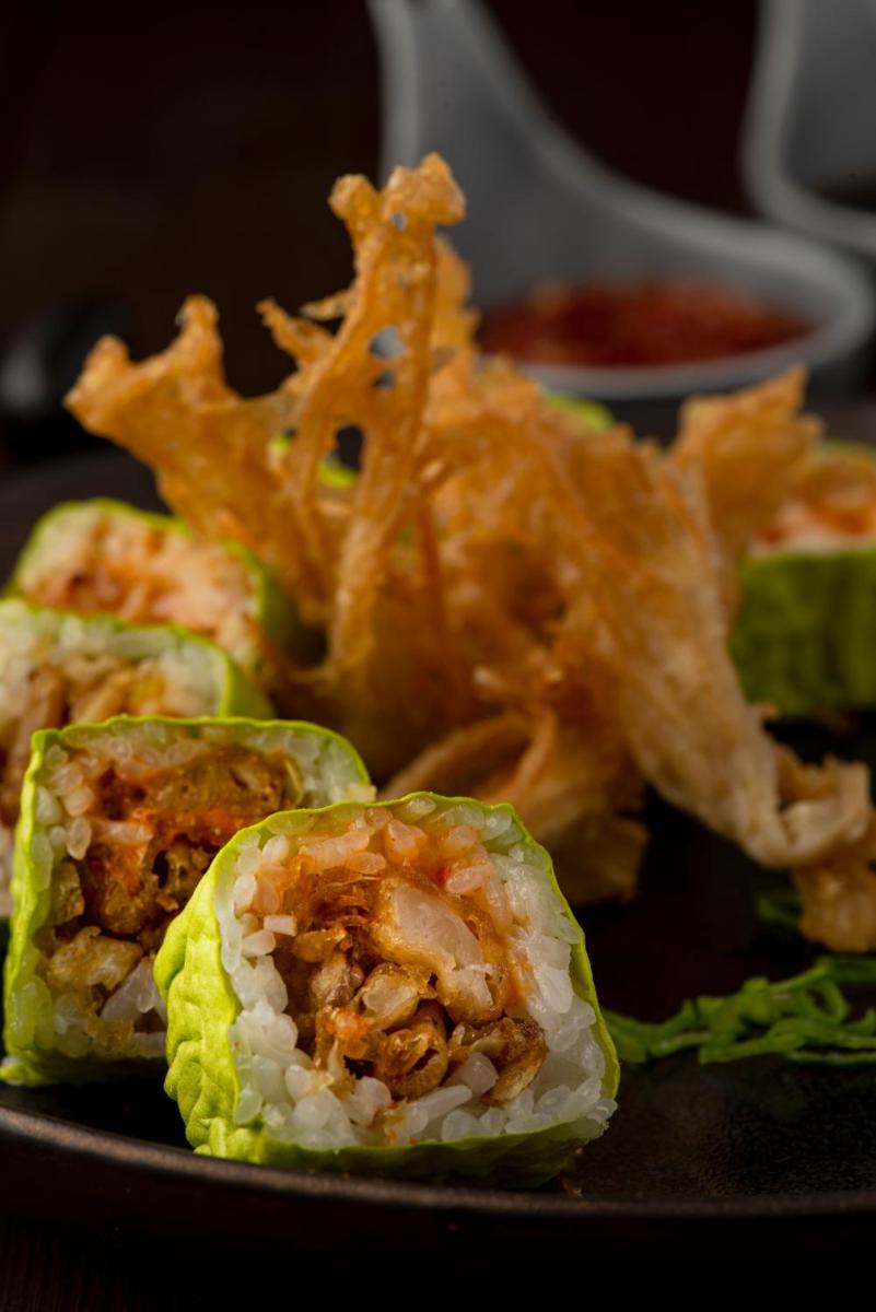 a black plate with some food on a table at Radisson Blu Plaza Delhi Airport in New Delhi a black plate with some food on a table at Radisson Blu Plaza Delhi Airport in New Delhi