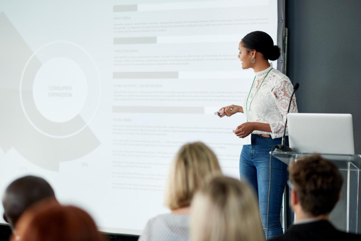 a woman standing in front of a screen giving a presentation at Hyatt Centric Janakpuri New Delhi in New Delhi