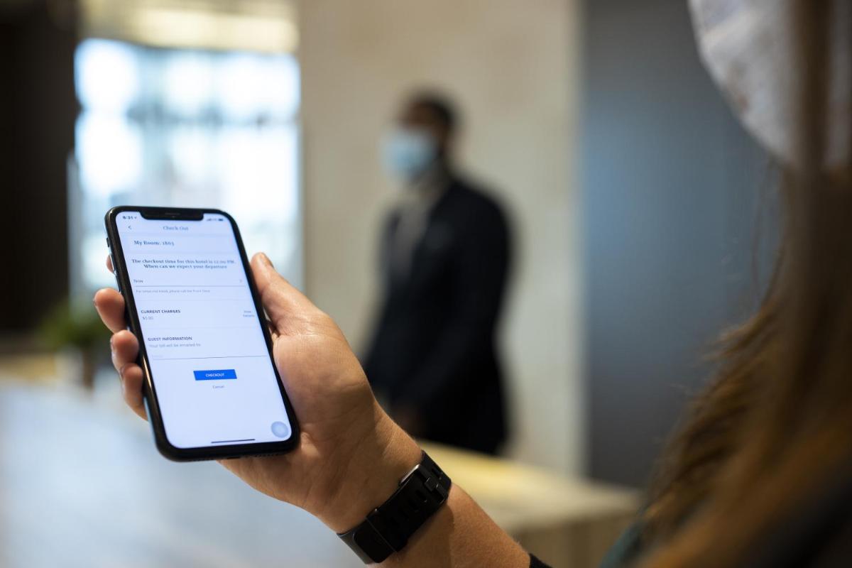 a person holding a iphone in their hand at Hyatt Centric Janakpuri New Delhi in New Delhi