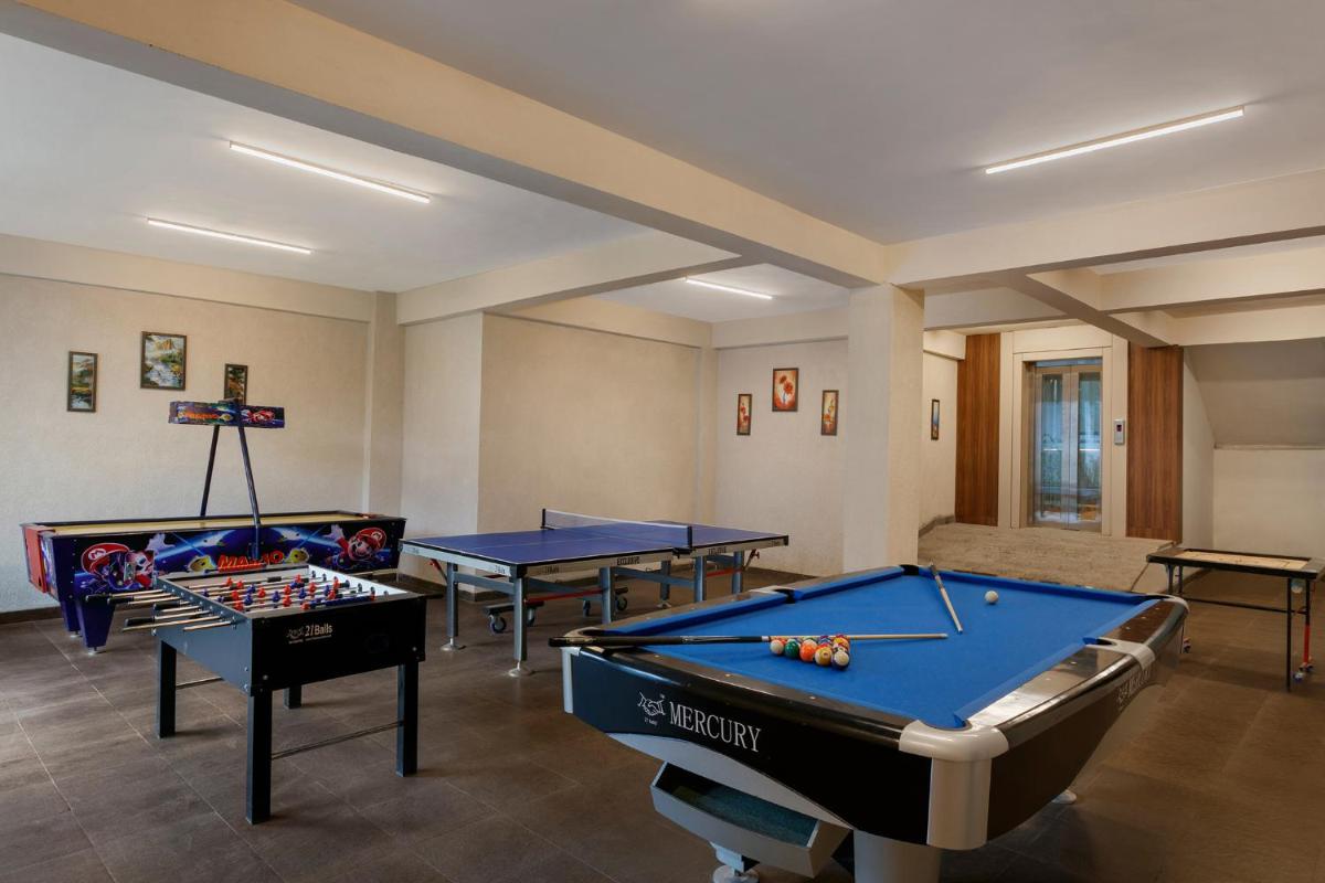 a room with four ping pong tables in it at The Orchid Manali - a Boutique Hotel in Manāli a room with four ping pong tables in it at The Orchid Manali - a Boutique Hotel in Manāli