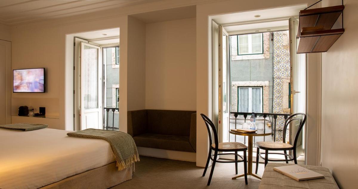 Uma cama ou camas num quarto em Lisboa Pessoa Hotel