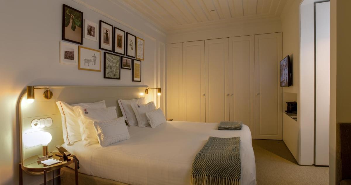 Uma cama ou camas num quarto em Lisboa Pessoa Hotel