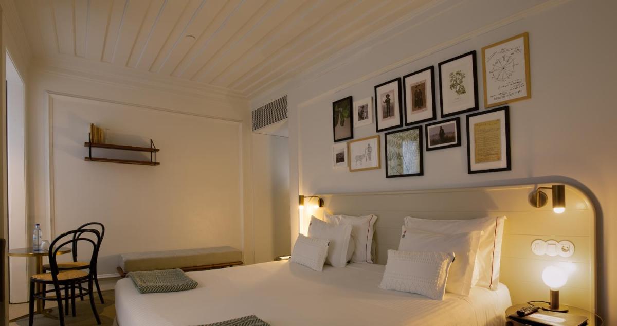 Uma cama ou camas num quarto em Lisboa Pessoa Hotel