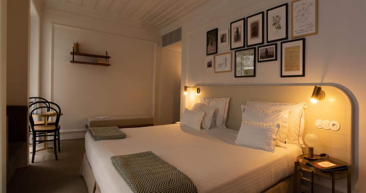Uma cama ou camas num quarto em Lisboa Pessoa Hotel