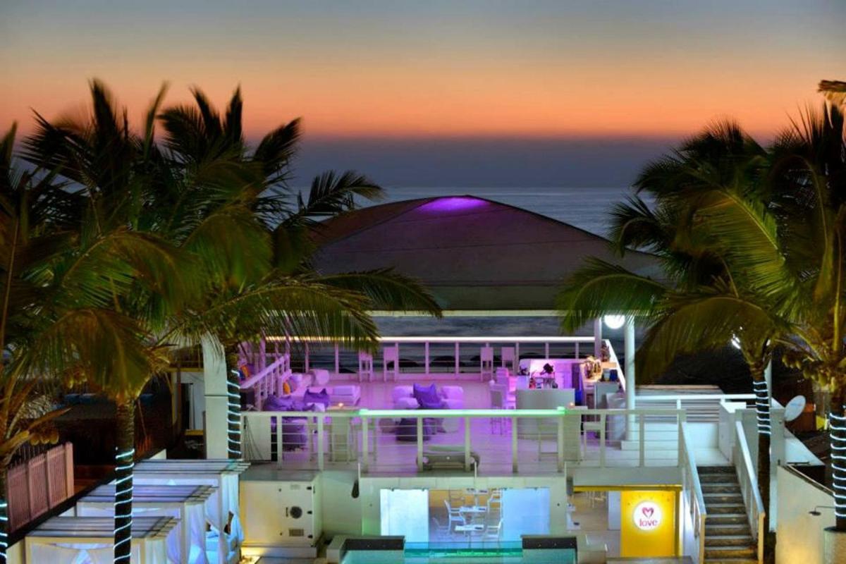 a view of a resort with palm trees and the ocean at The Park Calangute Goa in Calangute a view of a resort with palm trees and the ocean at The Park Calangute Goa in Calangute