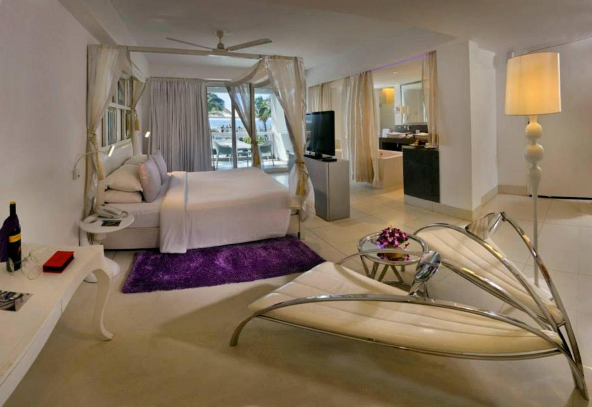 a bedroom with a bed and a living room at The Park Calangute Goa in Calangute a bedroom with a bed and a living room at The Park Calangute Goa in Calangute