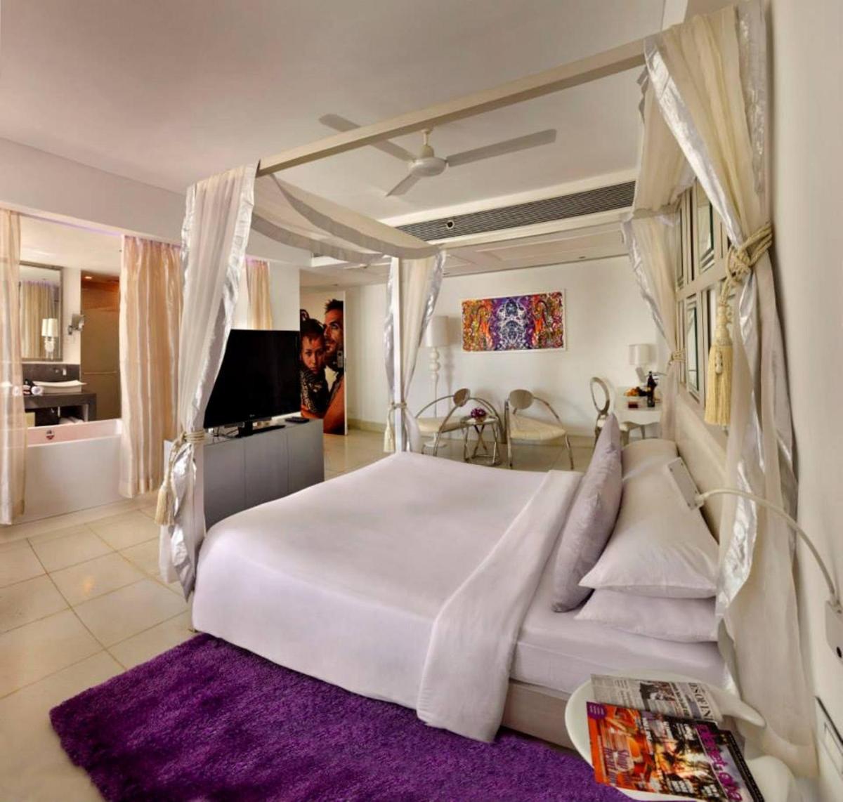 a bedroom with a white bed and a purple rug at The Park Calangute Goa in Calangute a bedroom with a white bed and a purple rug at The Park Calangute Goa in Calangute
