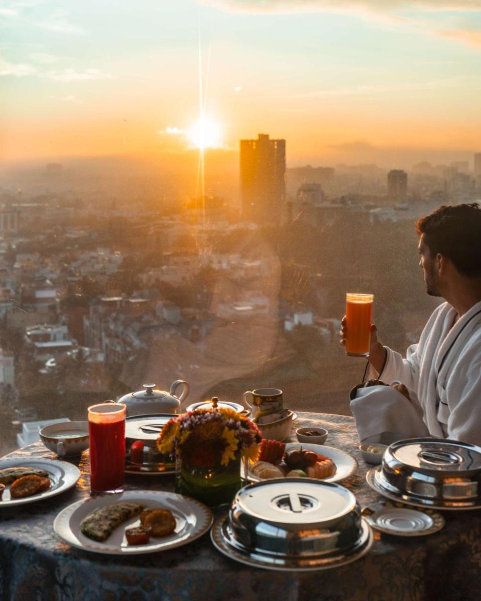 a man sitting at a table with plates of food at Shangri-La Bengaluru in Bengaluru a man sitting at a table with plates of food at Shangri-La Bengaluru in Bengaluru