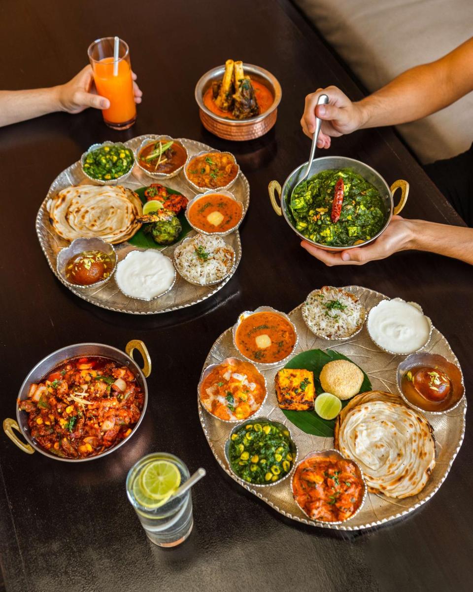 a table with plates of food and bowls of food at Shangri-La Bengaluru in Bengaluru a table with plates of food and bowls of food at Shangri-La Bengaluru in Bengaluru