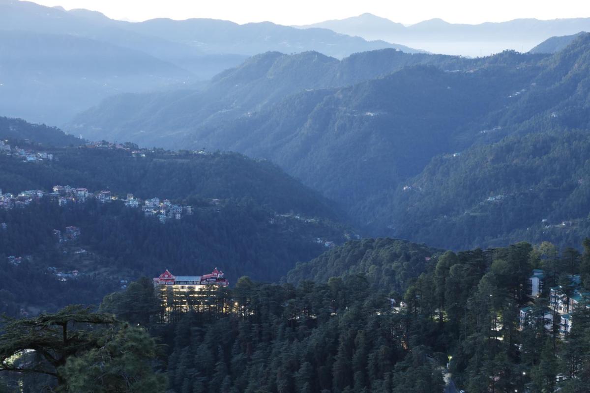 a view of a valley with mountains in the background at WelcomHeritage Elysium Resort & Spa in Shimla