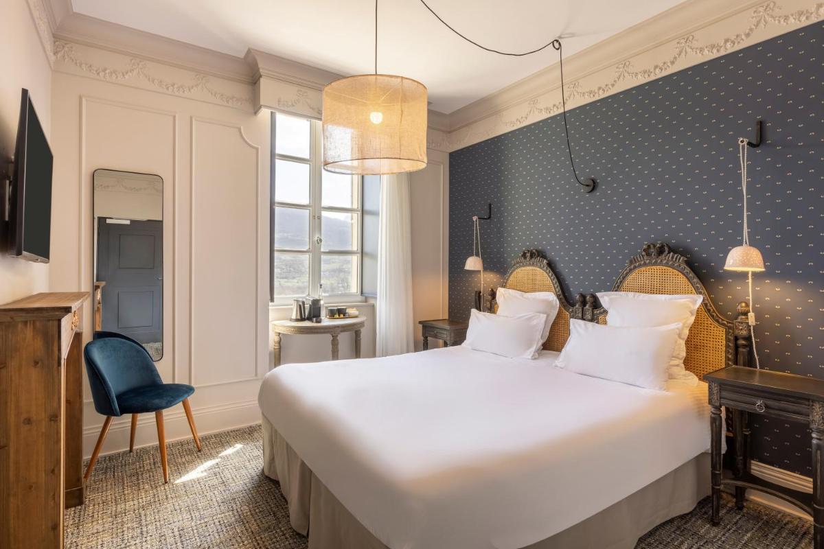 Un ou plusieurs lits dans un hébergement de l'établissement Hôtel La Robéyère - BW Signature Collection