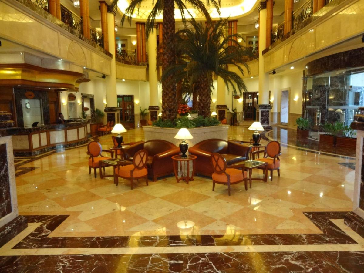 a lobby with chairs and tables in a building at The Residency Towers in Chennai