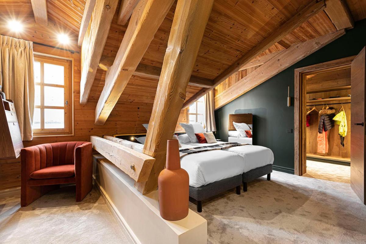 Un ou plusieurs lits dans un hébergement de l'établissement Hotel Le Chabichou