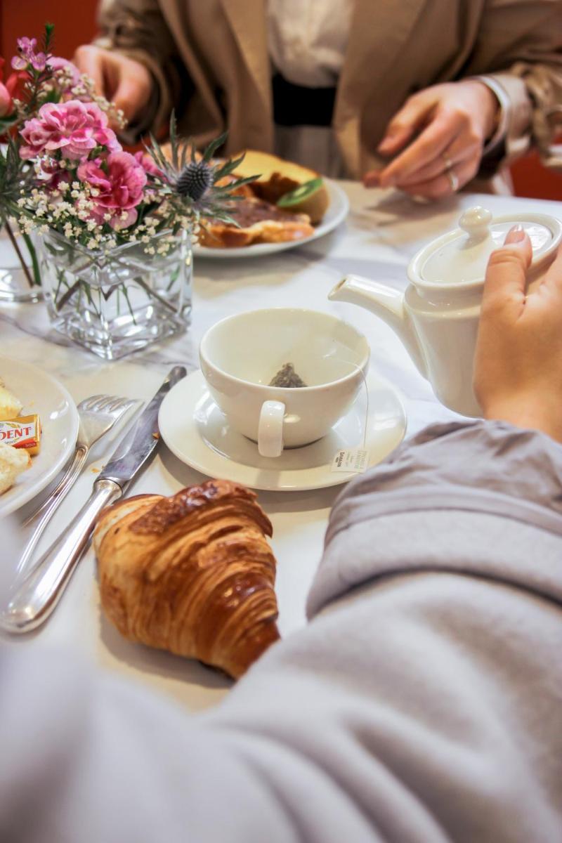 - une table avec des assiettes de nourriture et des pâtisseries dans l'établissement Hôtel Le Petit Périer, à Laval