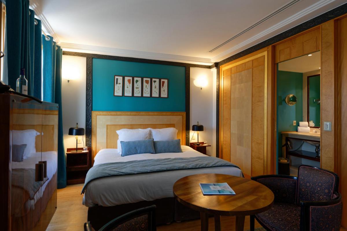 Un ou plusieurs lits dans un hébergement de l'établissement HR Hôtel-Restaurant & Spa Marin