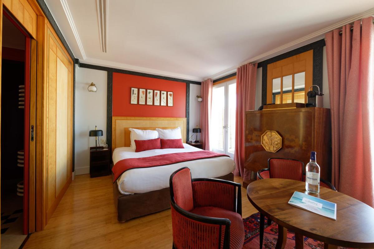 Un ou plusieurs lits dans un hébergement de l'établissement HR Hôtel-Restaurant & Spa Marin