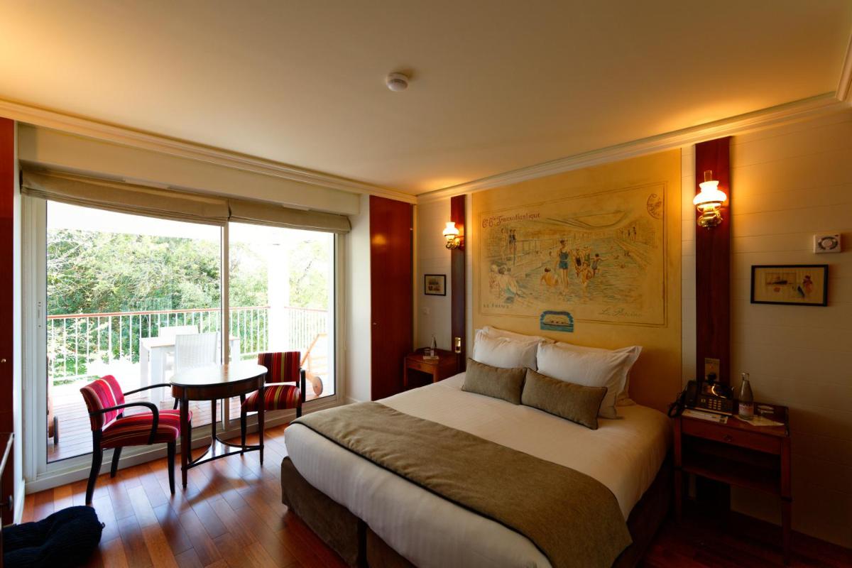 Un ou plusieurs lits dans un hébergement de l'établissement HR Hôtel-Restaurant & Spa Marin Un ou plusieurs lits dans un hébergement de l'établissement HR Hôtel-Restaurant & Spa Marin