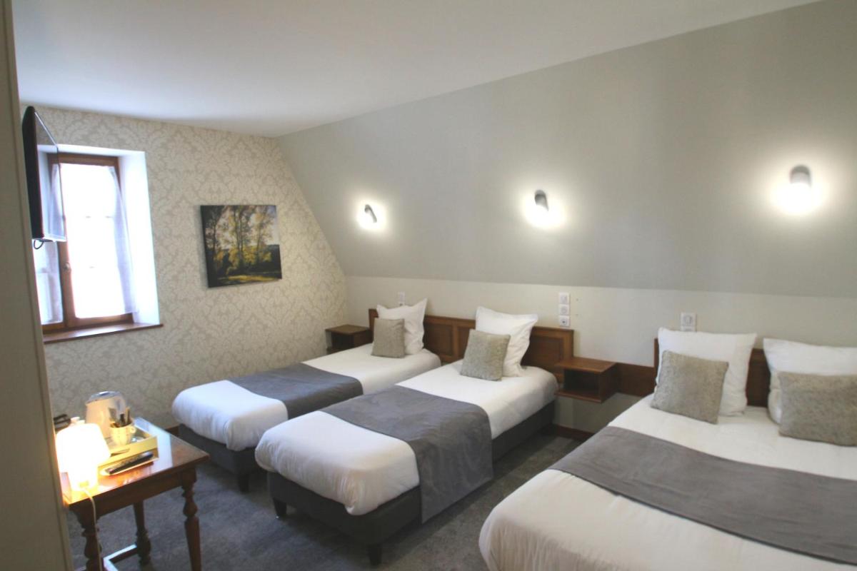 Un ou plusieurs lits dans un hébergement de l'établissement Logis Hotel Archambeau