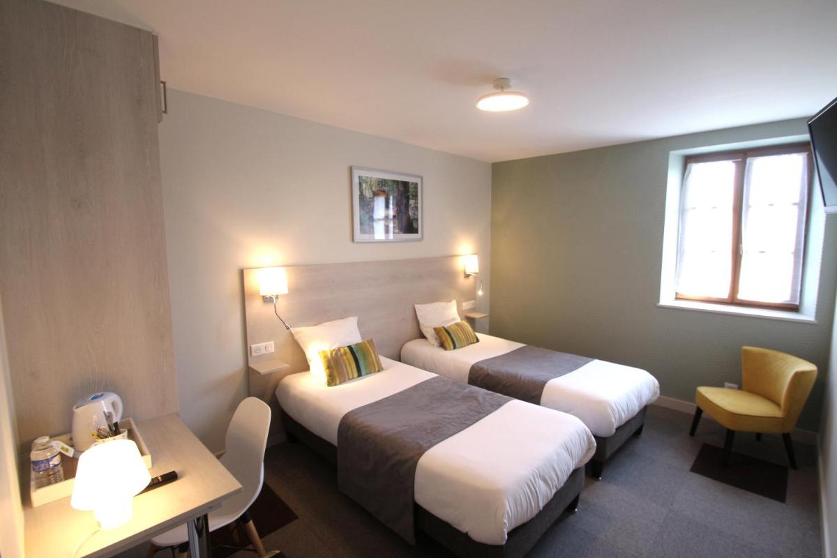 Un ou plusieurs lits dans un hébergement de l'établissement Logis Hotel Archambeau