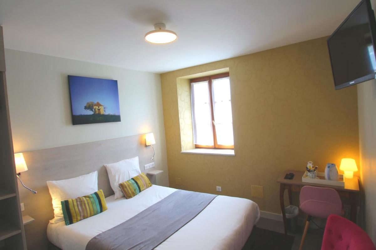 Un ou plusieurs lits dans un hébergement de l'établissement Logis Hotel Archambeau