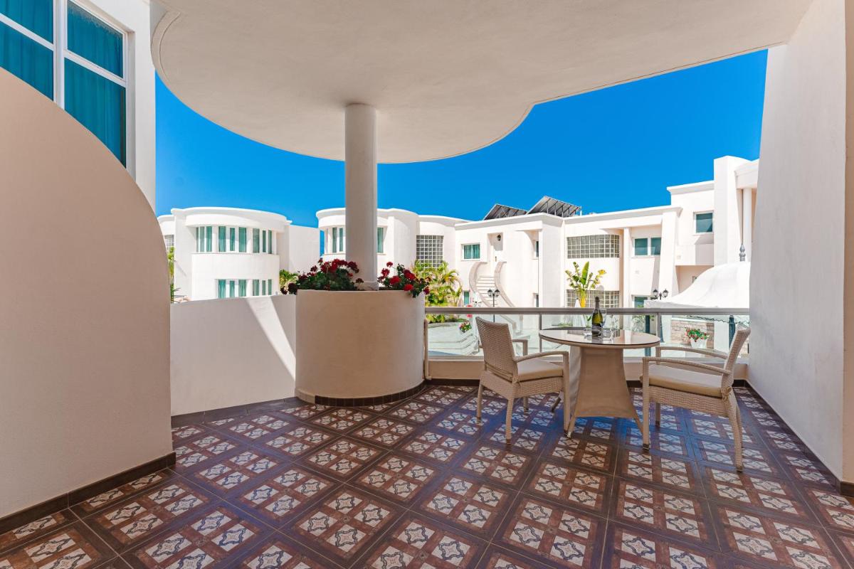 vistas al balcón de un hotel con mesa y sillas en Flamingo Suites Boutique Hotel, en Adeje