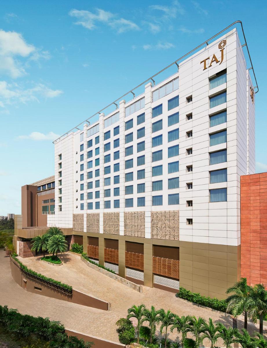 a tall white hotel with a sign on it at Taj City Centre New Town, Kolkata in Kolkata a tall white hotel with a sign on it at Taj City Centre New Town, Kolkata in Kolkata